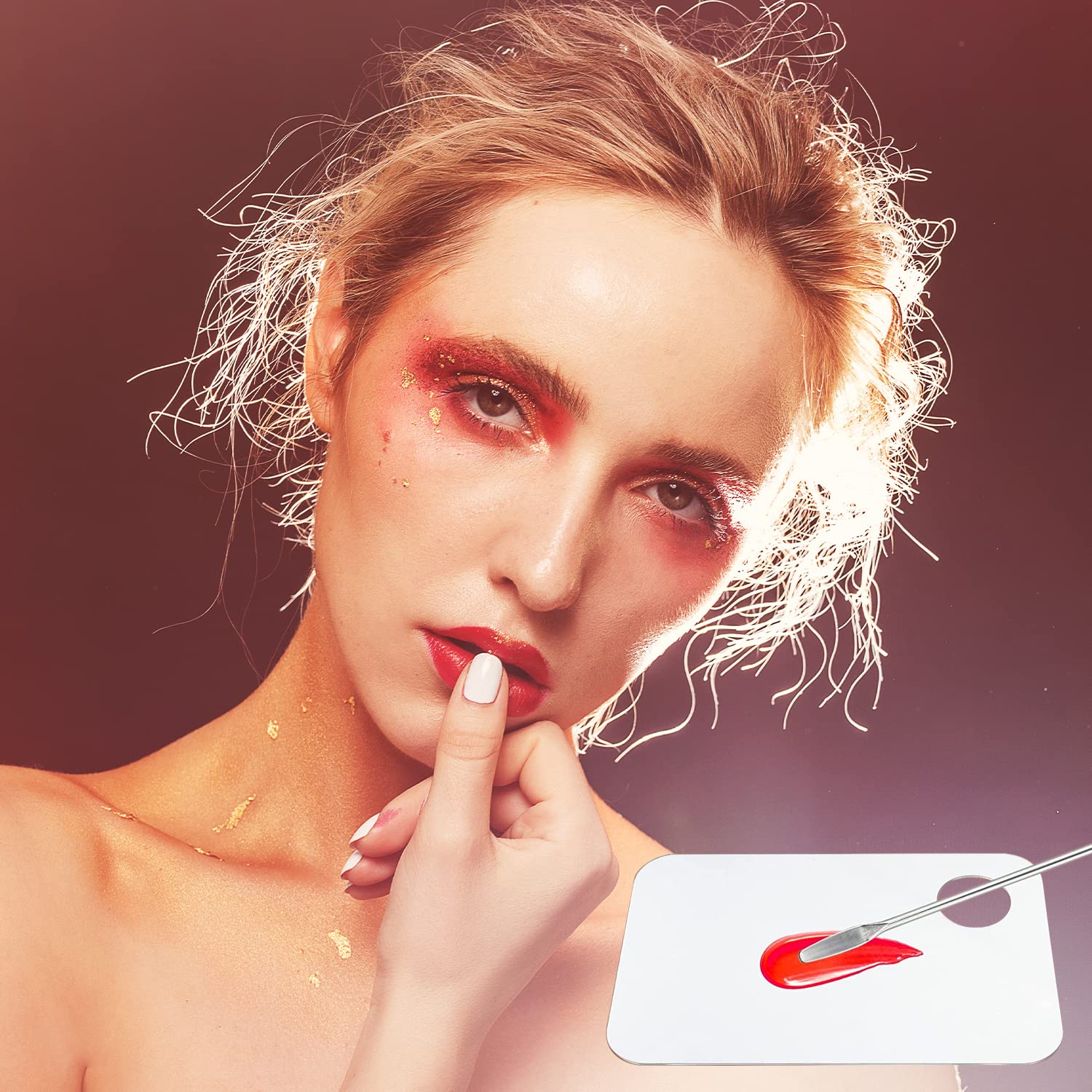 Professional makeup artist using clear acrylic mixing tray