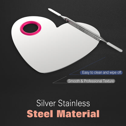 Hand holding heart shaped stainless steel makeup palette by thumb hole