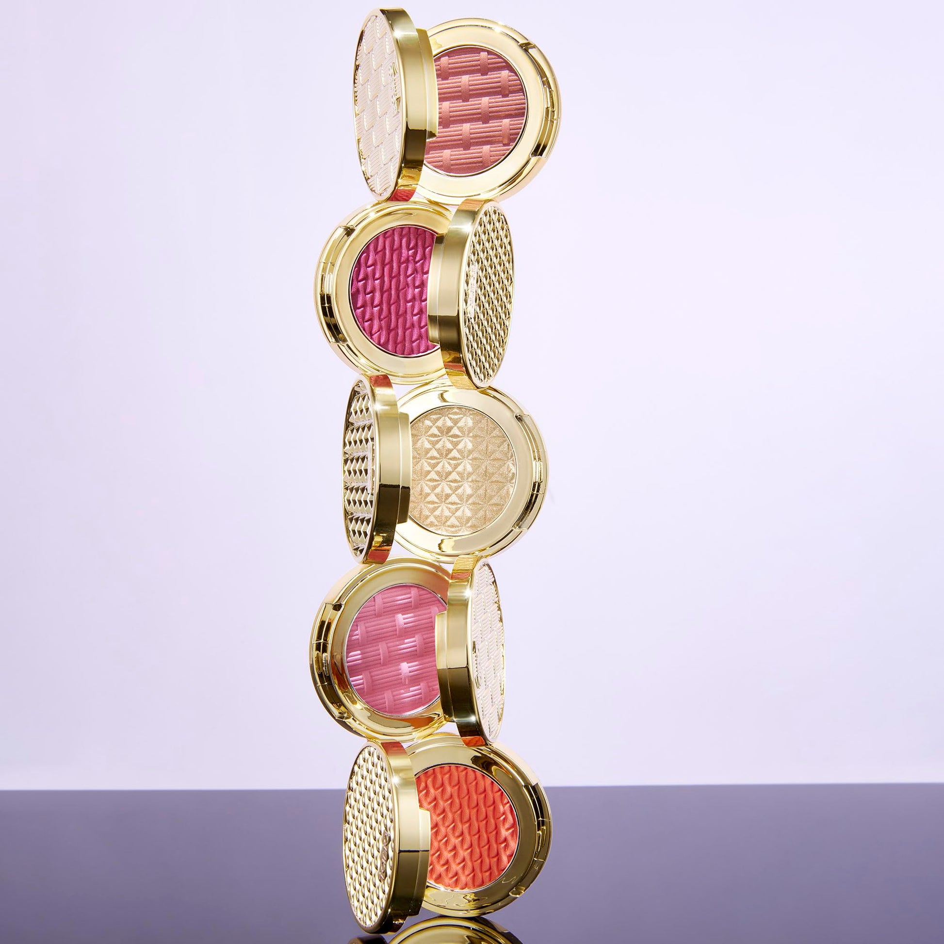 Swatches of the five buildable vegan blush shades on diverse skin tones showing pigment payoff.