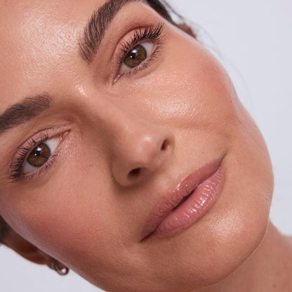 EarthsCure luminous highlighter stick capturing light for a dewy youthful glow