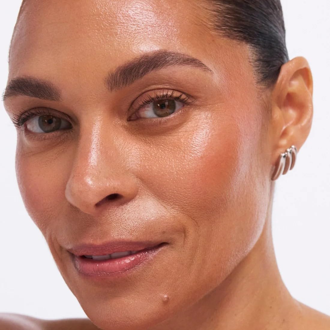 Swatches of EarthsCure bronzer blush and highlighter cream formulas on diverse skin tones