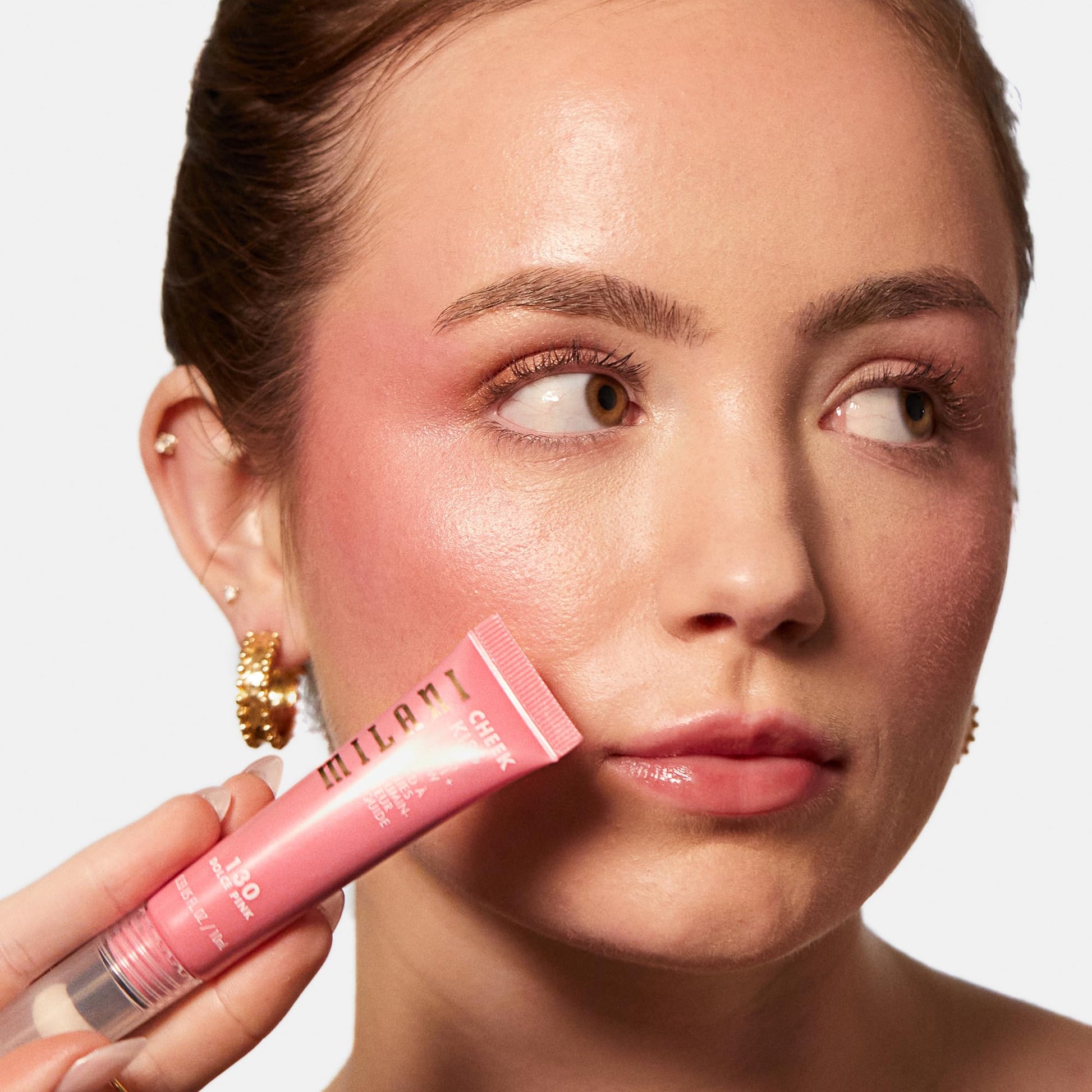 Milani Dolce Pink liquid blush swatch on skin showcasing the dewy pearl pigment radiance