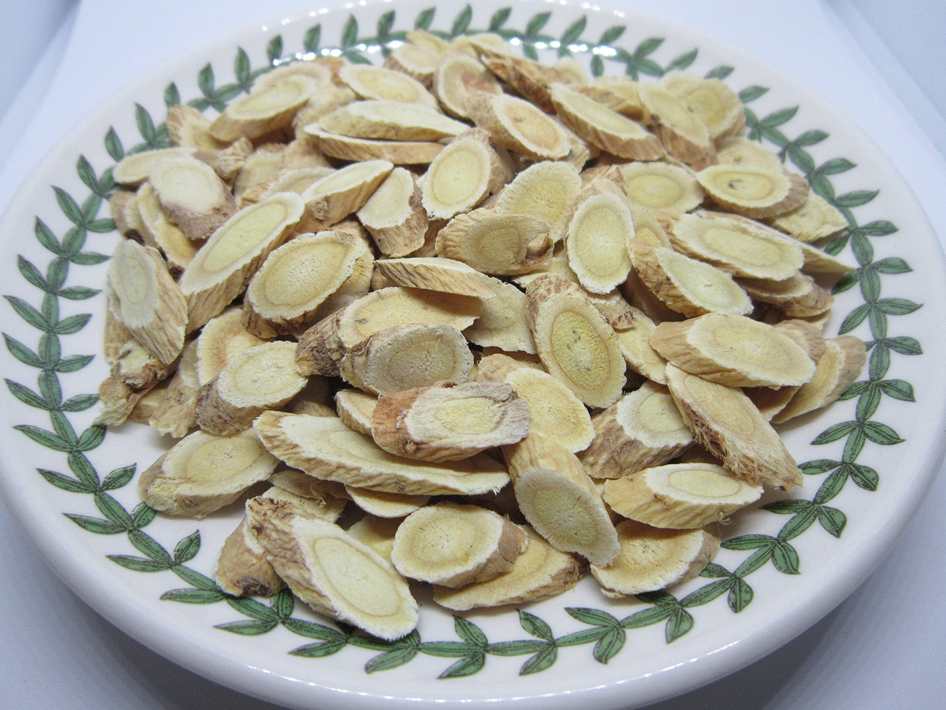 Nature Tea Astragalus membranaceus root slices close up view displaying premium traditional Chinese medicine herb quality.