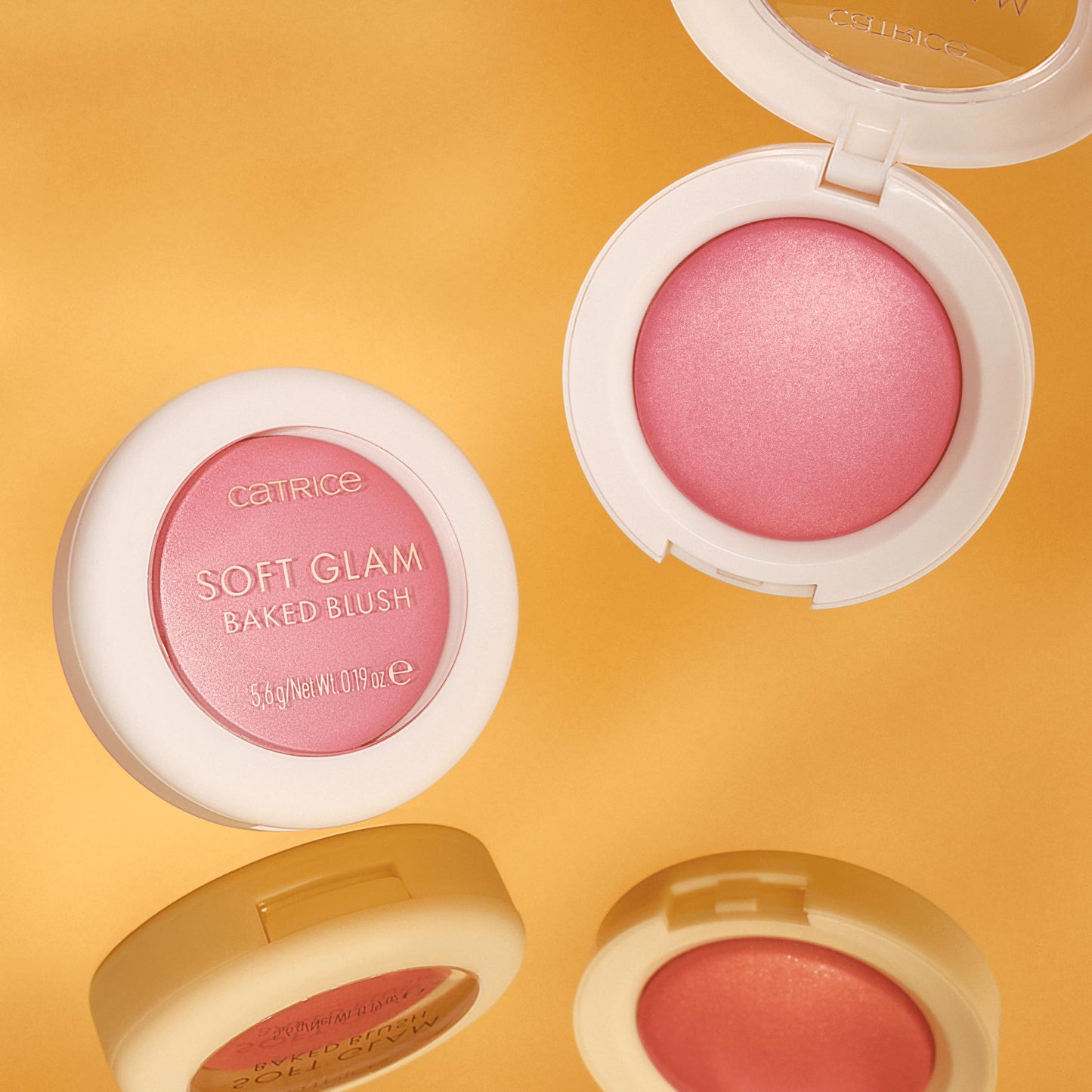 Swatches of the buildable Catrice Soft Glam powder blush on different skin tones under natural lighting.