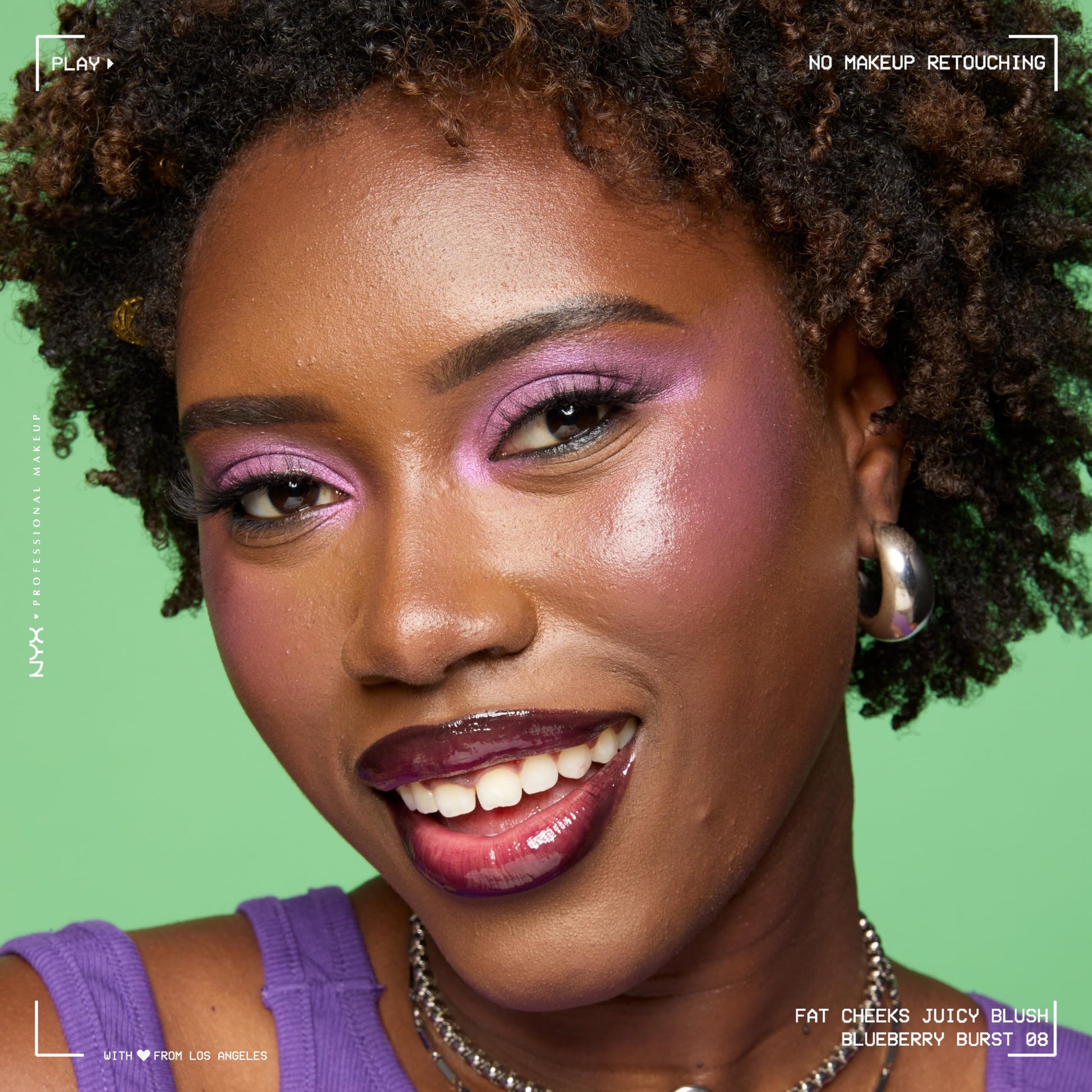 Model with dewy makeup look showing the color payoff of Blueberry Burst liquid blush