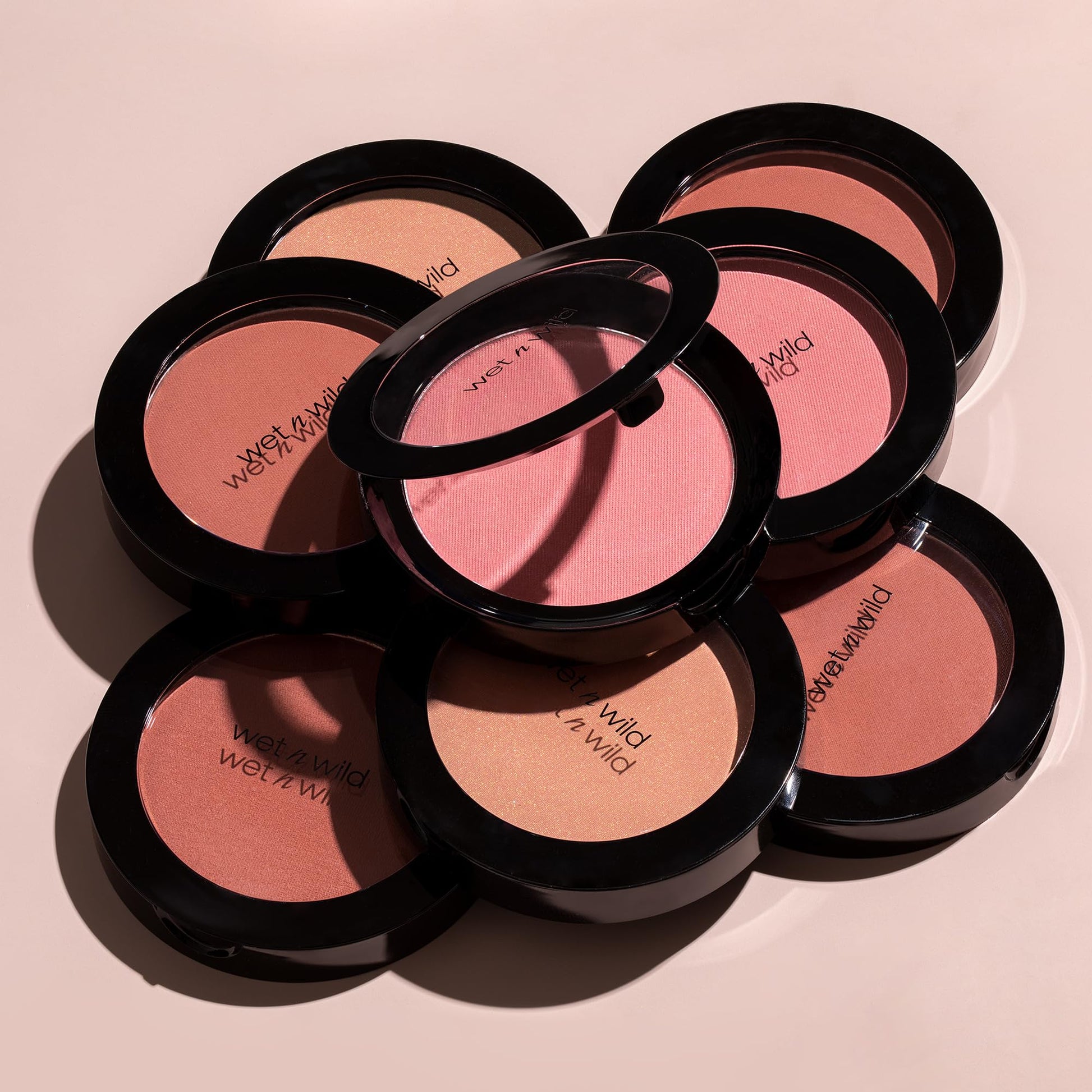 Wet n Wild imported cosmetic blush compact styled next to natural beauty ingredients