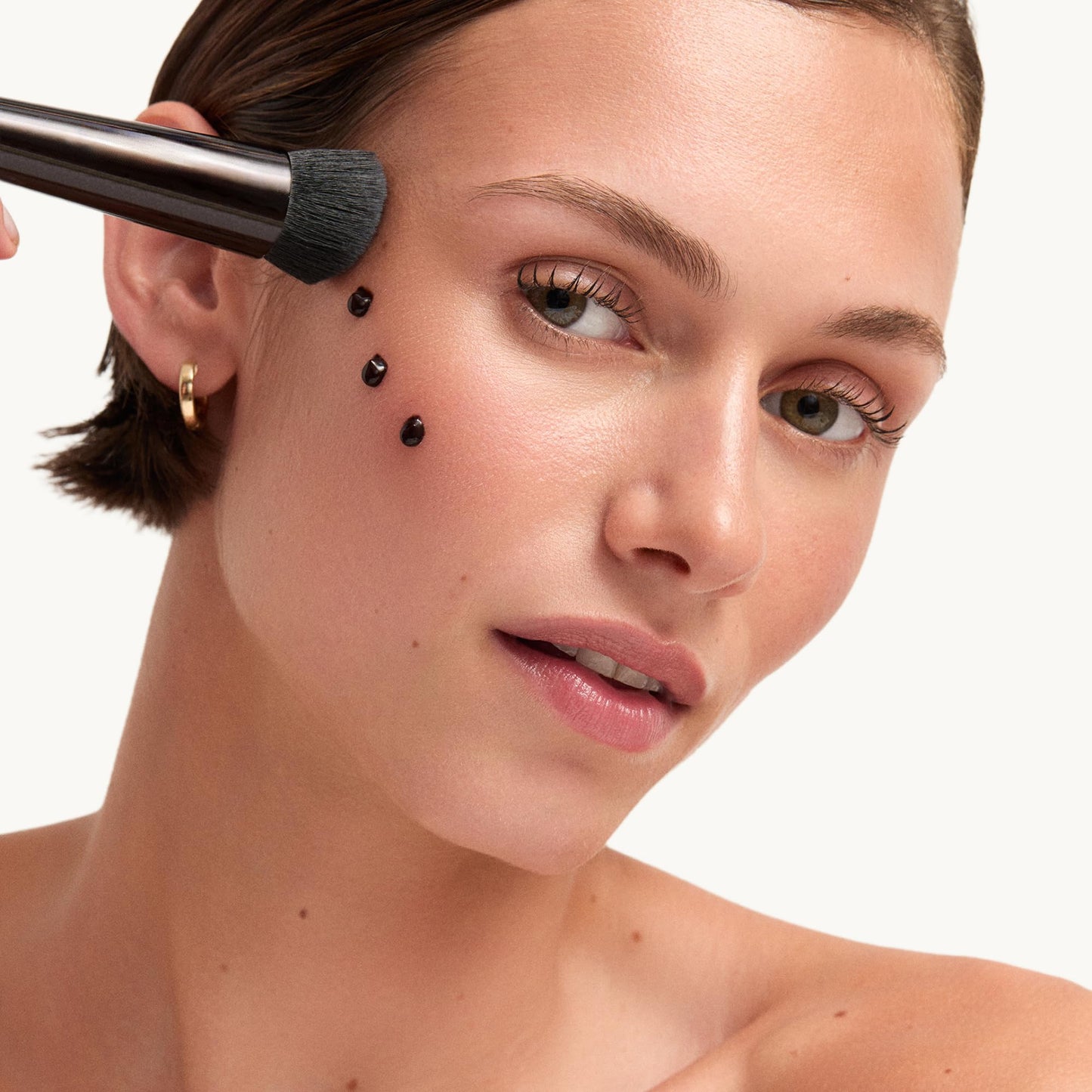 Goop Beauty antioxidant infused bronzing gel tube standing upright alongside its external box.