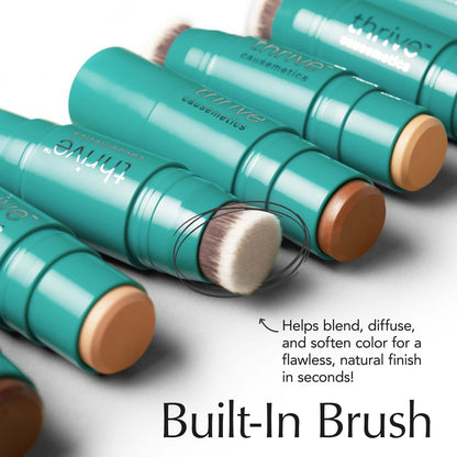 Waterproof cream bronzer stick showing the built-in blending brush side
