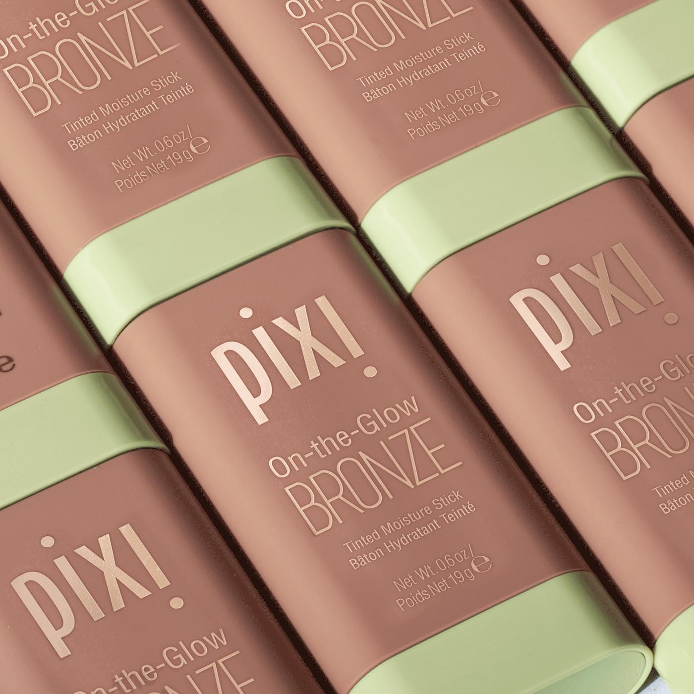 Pixi beauty bronzing stick displayed upright next to its official outer box.