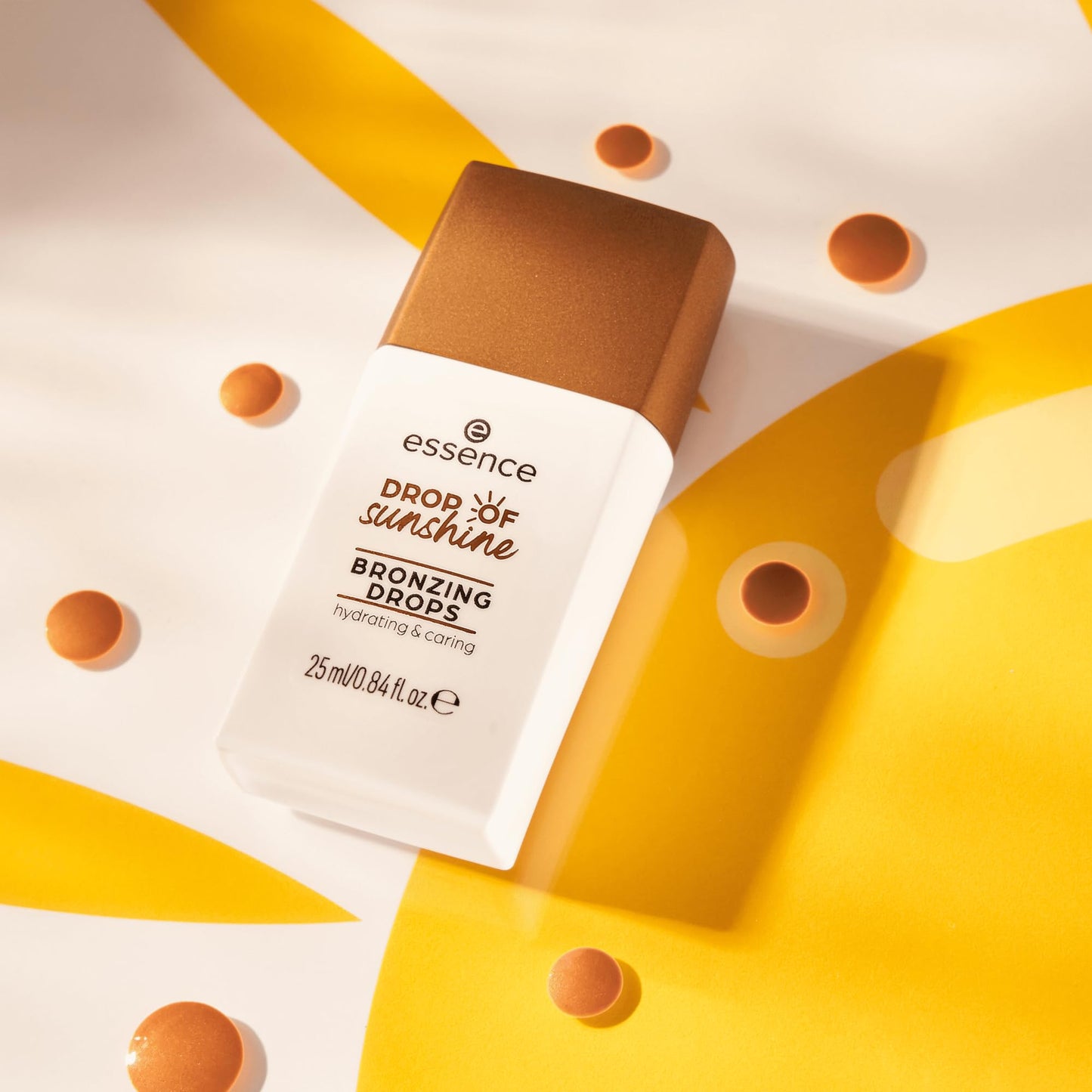 Essence Drop Of Sunshine highlighting drops showing the sleek product packaging tailored for a luminous summer glow.