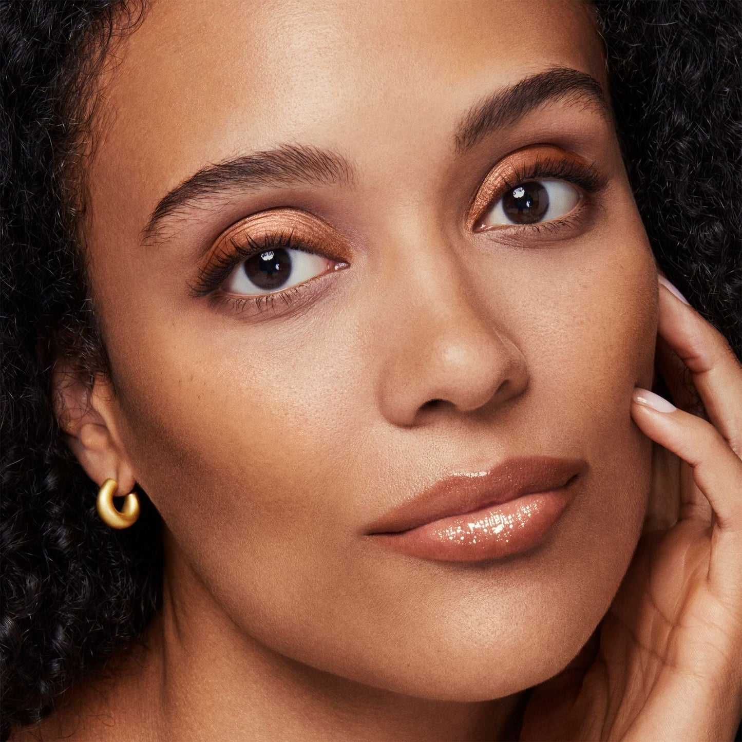 Open jar of bareMinerals All Over Face Color Warmth showing the concentrated terracotta bronze powder.