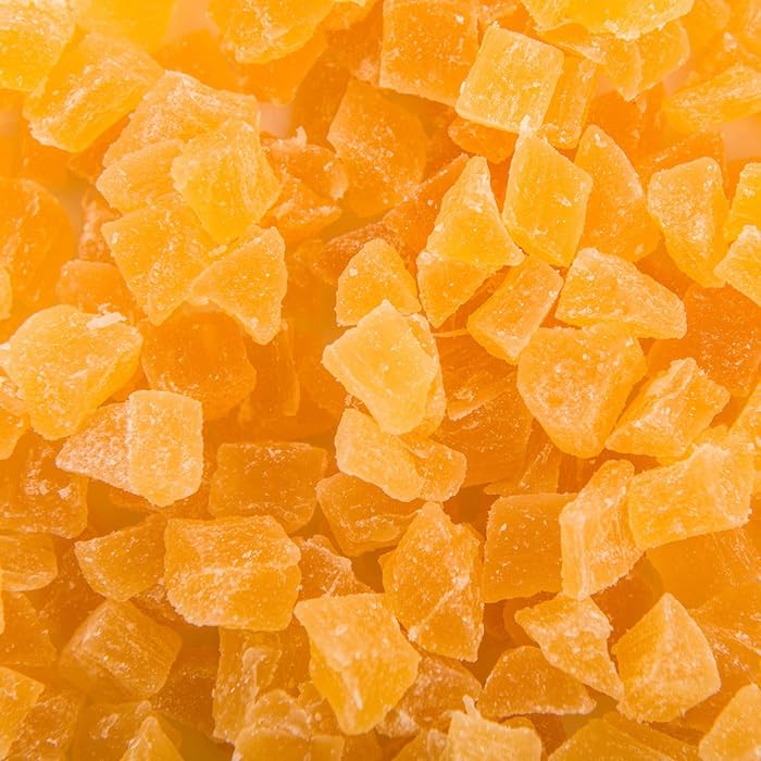 Dried Bael fruit slices scattered next to the one kilogram packaging highlighting the natural texture and quality.