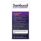 Child holding Sambucol black elderberry syrup bottle