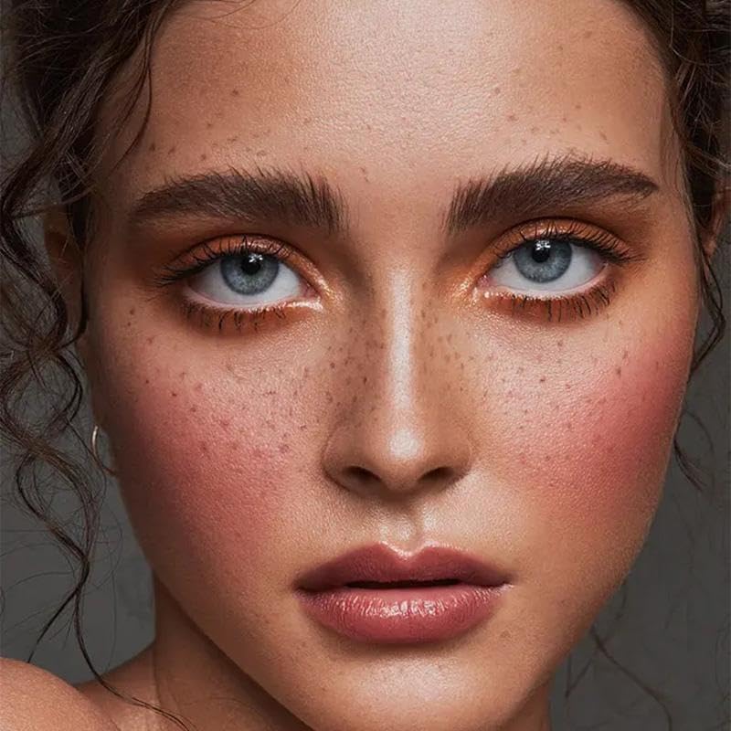 Sunkissed brown liquid freckle tint application close up on cheek skin texture showing blendable finish.