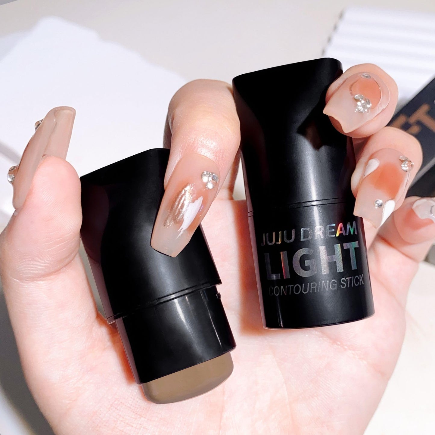 Matte cool-toned cream contour stick showing the Cold Gray Brown makeup product extended.