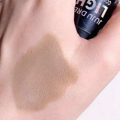 Lightweight buildable contour stick for fair skin being swatched on a surface.