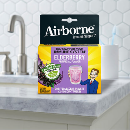 Airborne authentic USA imported wellness tablets being dropped into a clean glass of clear drinking water
