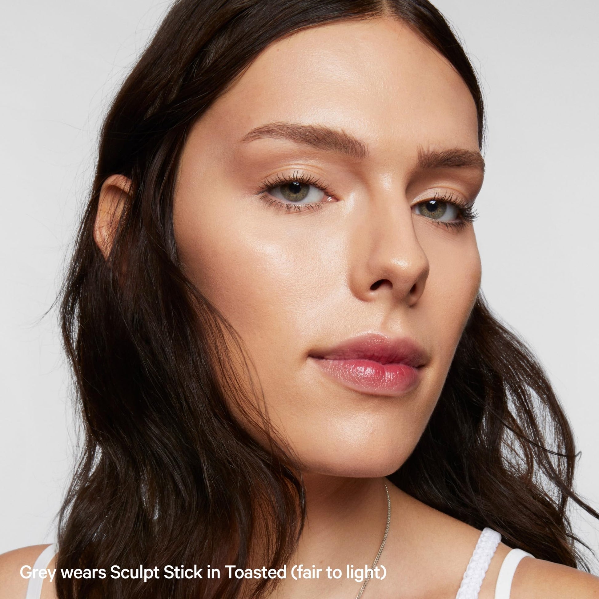 Imported USA makeup Milk Makeup brand cream contour stick on a neutral background