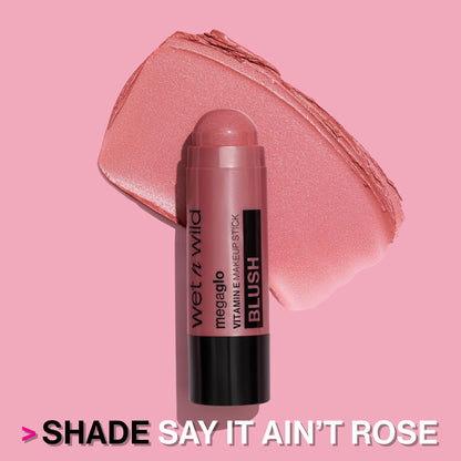 Travel friendly pink makeup stick next to a beauty vanity setup