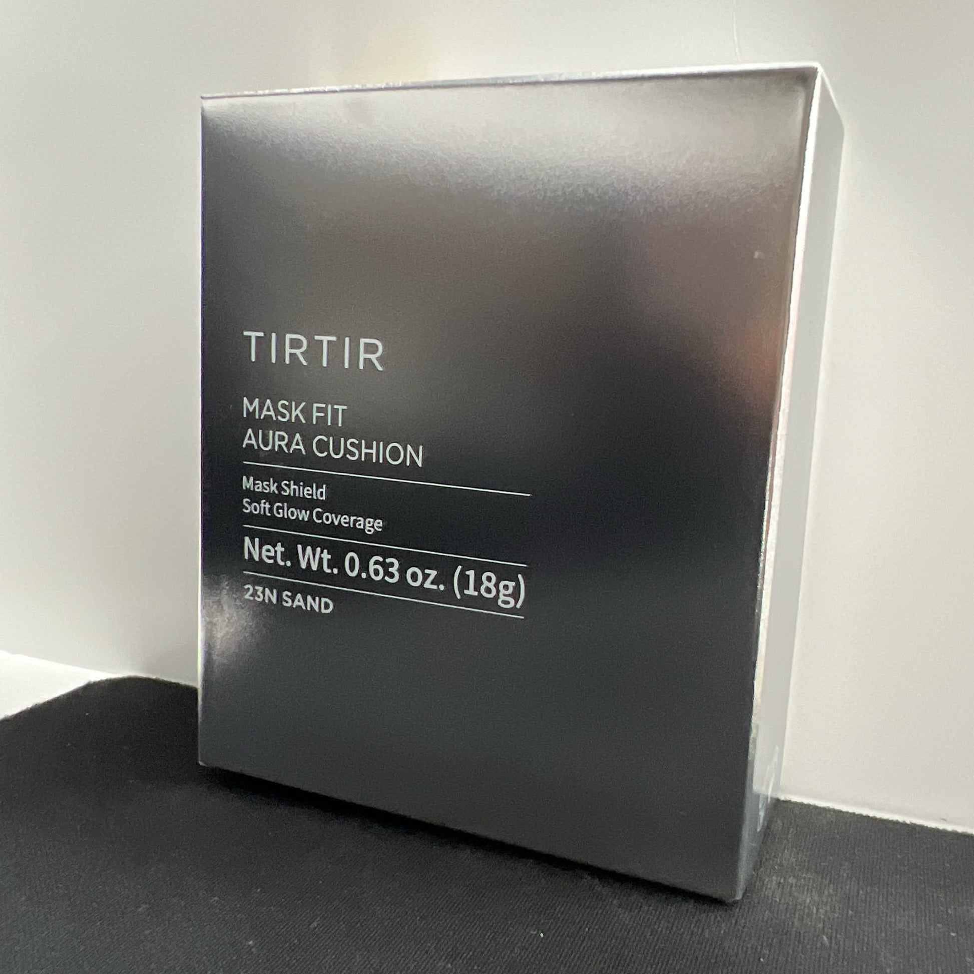 Close up view of the TIRTIR cushion puff applicator being pressed into the foundation