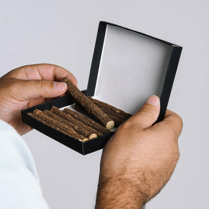 Hand holding Biorr natural licorice root chew stick