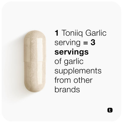 Two vegetarian garlic capsules resting next to the authentic imported wellness bottle.