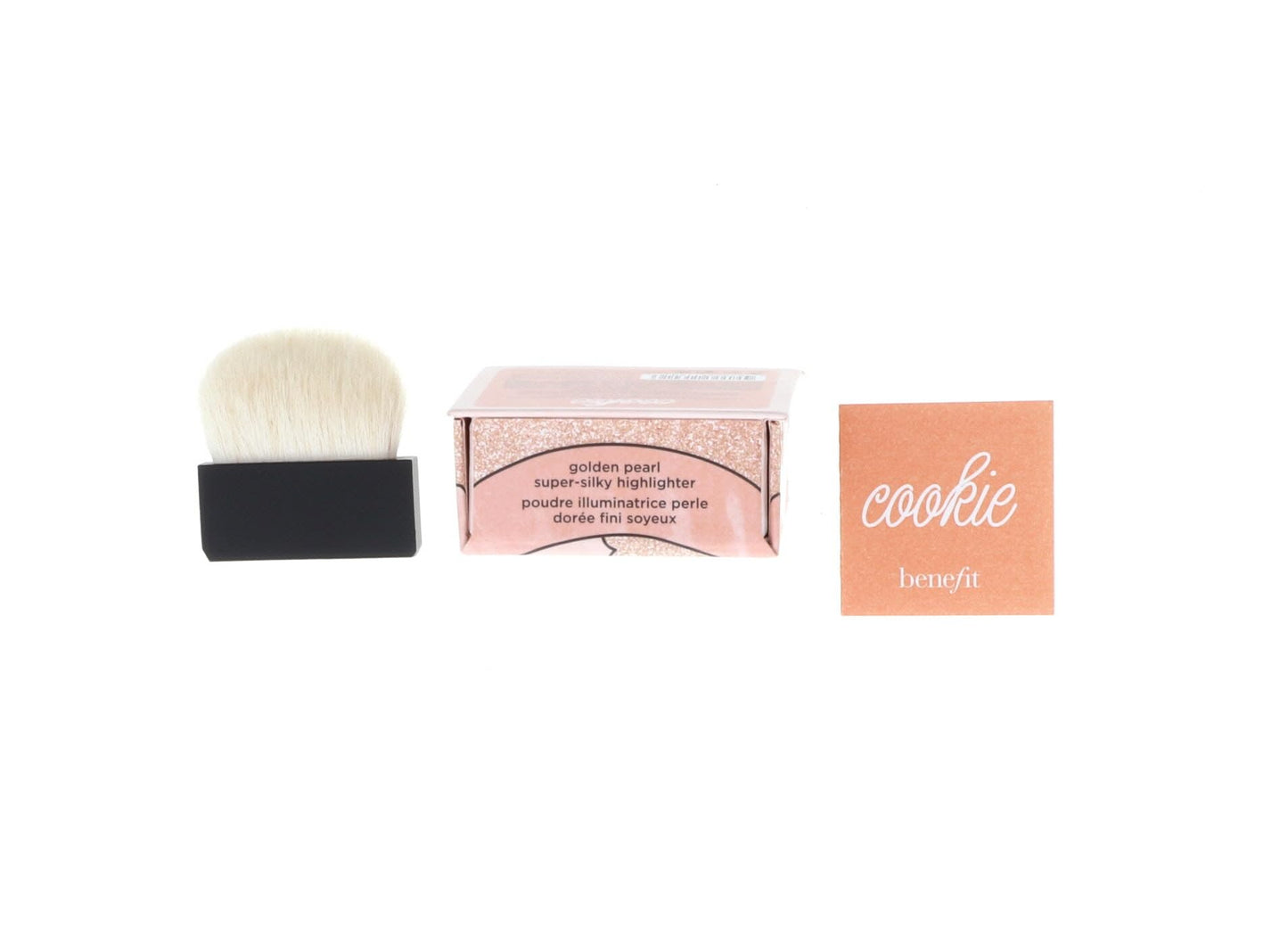 An overhead shot of the Benefit Cookie face illuminator compact next to its product box displaying authentic USA branding.