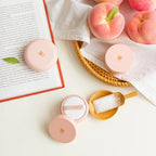 Skinfood Peach Cotton Pore Blur Pact lifestyle setting with peach elements