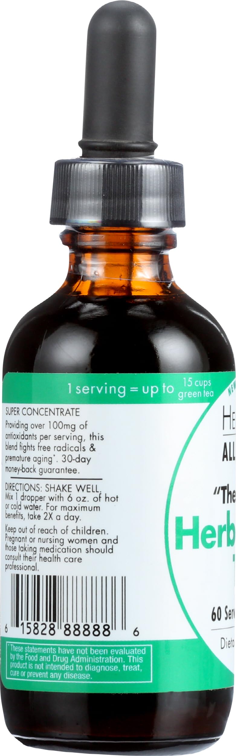 Bottle of HerbaGreen Tea next to glass of water