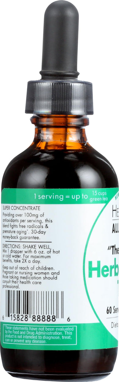 Bottle of HerbaGreen Tea next to glass of water