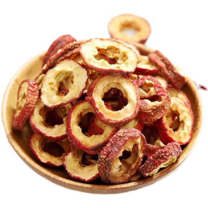 Sun dried seedless hawthorn fruit slices arranged neatly on a wooden surface
