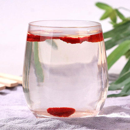 Steeping natural sweet and sour dried hawthorn berry tea infusion in a glass cup