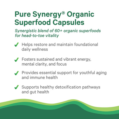 Pure Synergy Organic Greens Supplement vegan capsules being held for daily health routine visualization