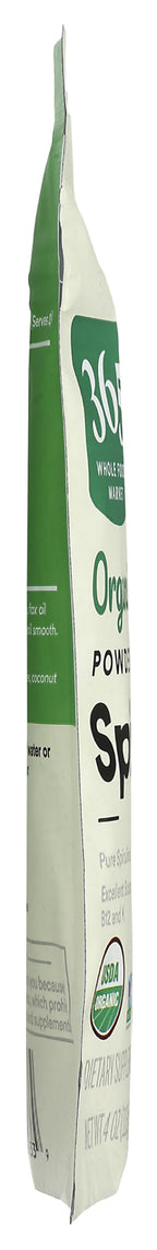 Imported USA organic spirulina powder being scooped for a healthy green smoothie blend