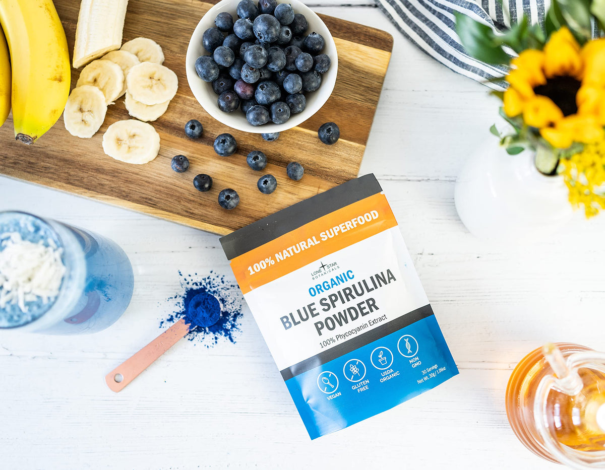 Vibrant blue smoothie bowl topped with berries prepared using Lone Star Botanicals Organic Spirulina.