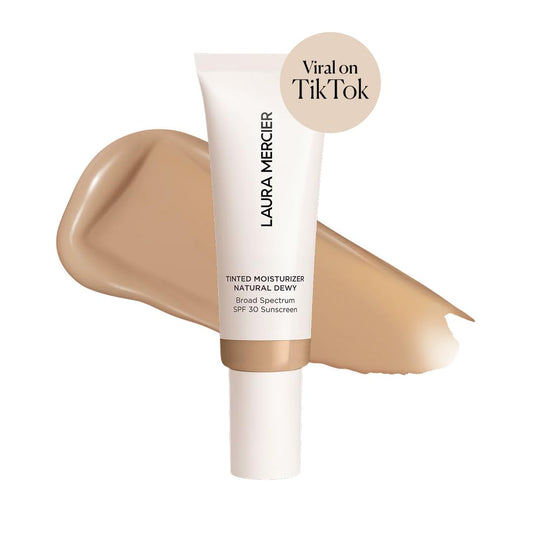Laura Mercier skin tint cream texture swatched on a clean surface showing sheer buildable coverage.
