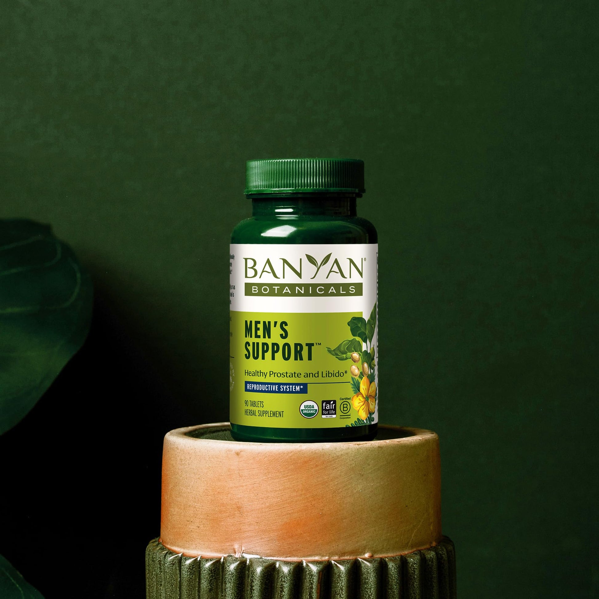 Side view of Banyan Botanicals daily herbal supplement bottle with organic certification symbols.