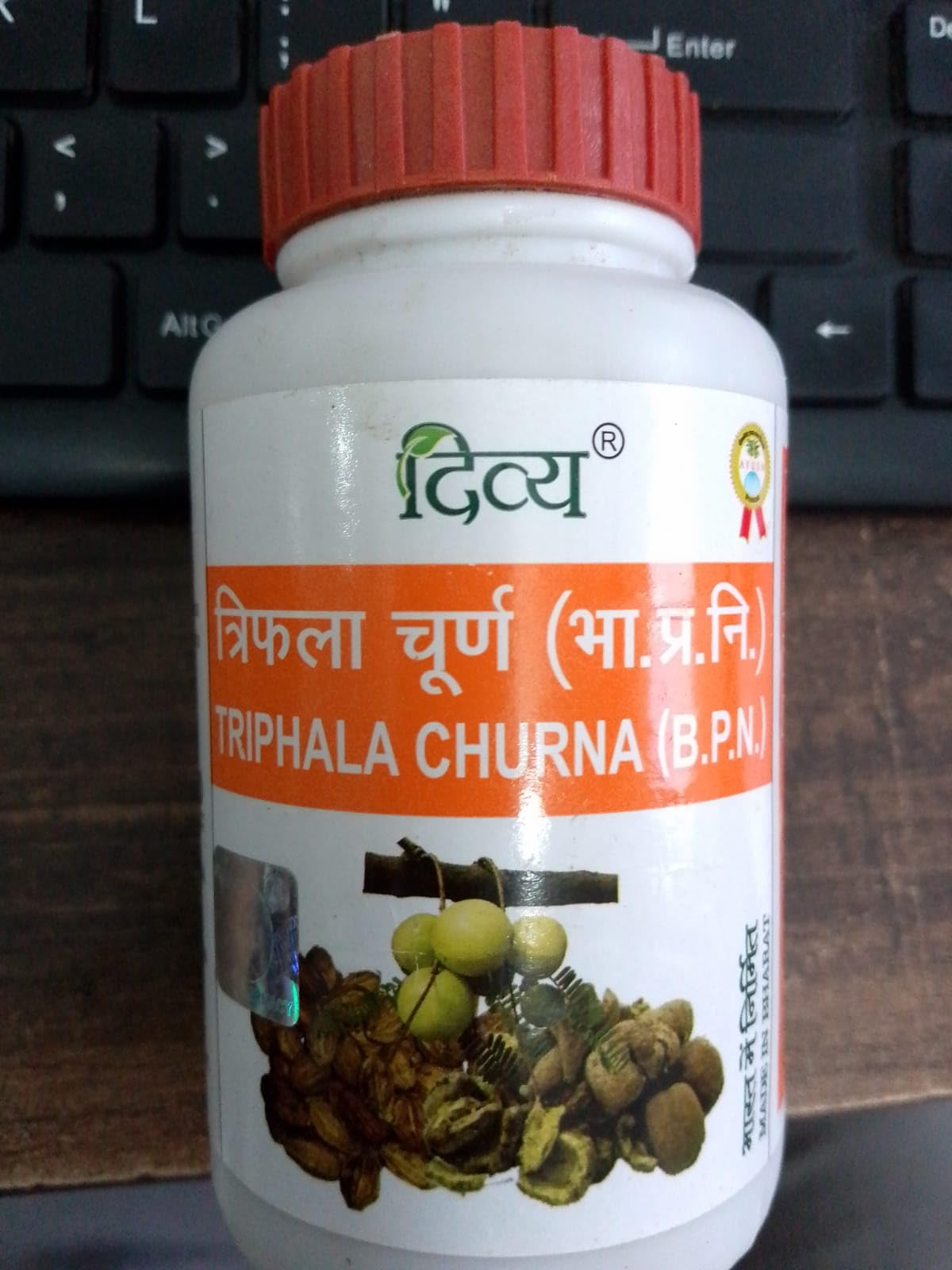 Patanjali Triphala Churna container back panel showcasing product ingredients, directions for use, and manufacturing details.