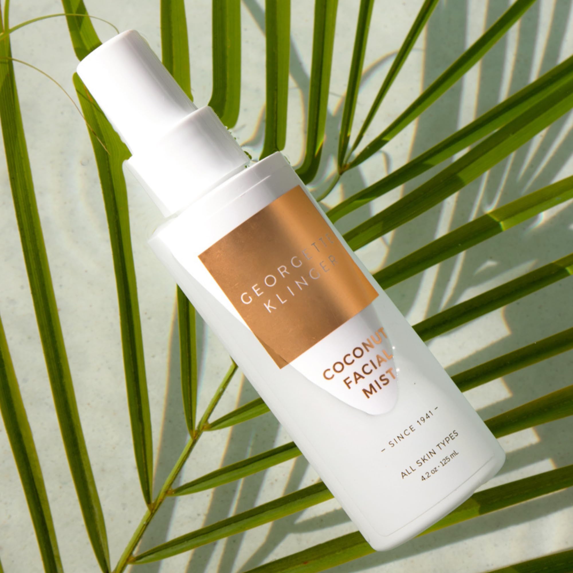 Hydrating face spray bottle by Georgette Klinger showing liquid clarity and nozzle