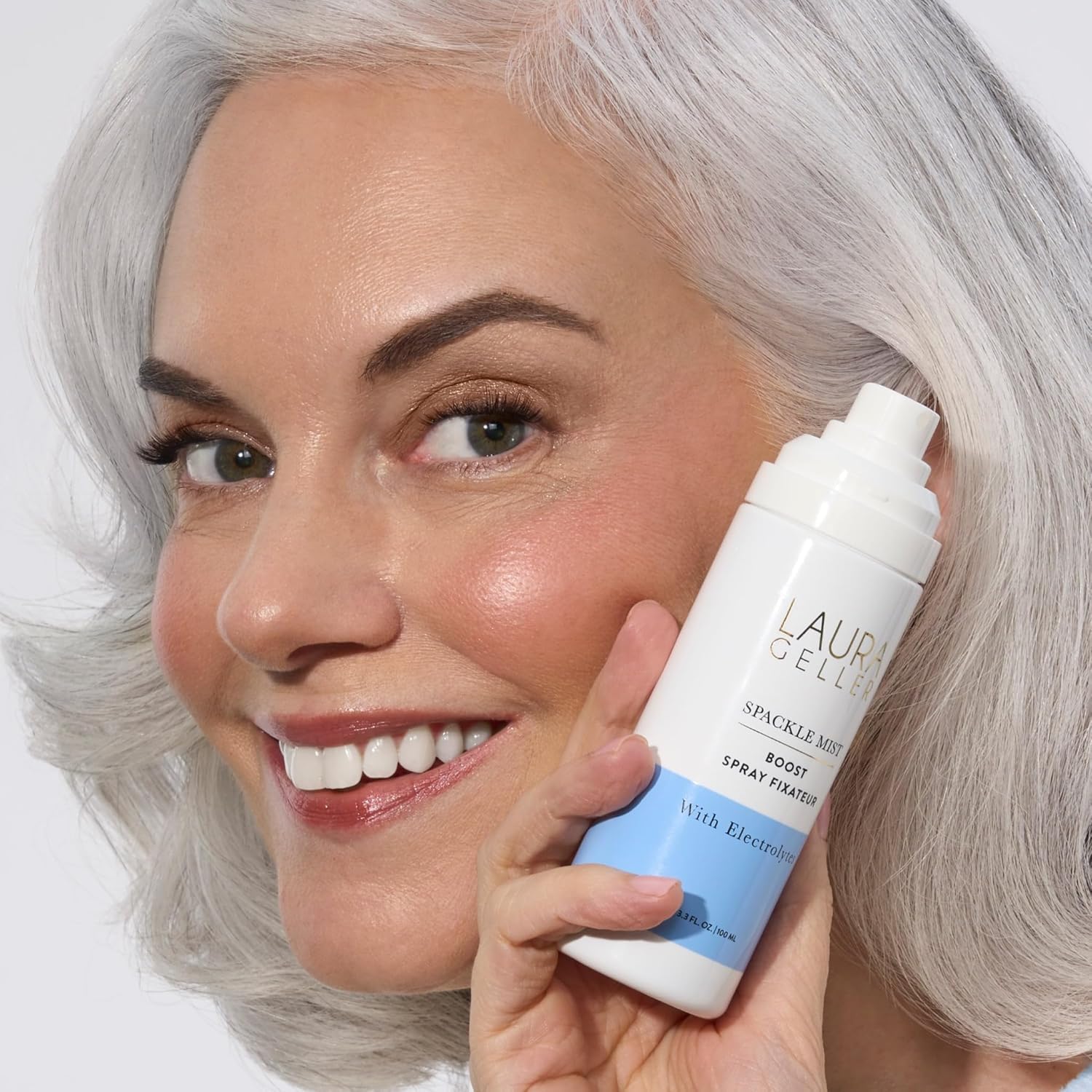 Laura Geller Spackle Mist spray bottle demonstrating the ultra fine liquid mist