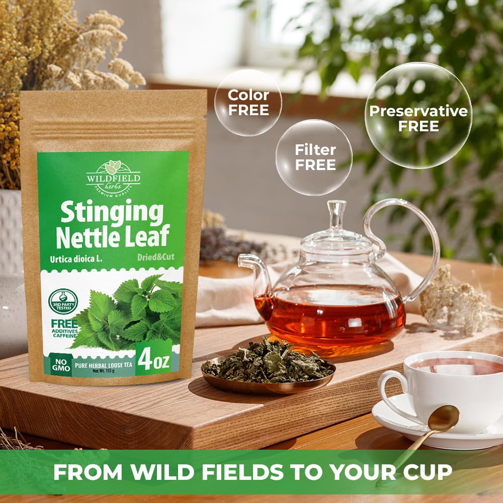 Brewed cup of hot Wildfield Herbs stinging nettle leaf tea with loose herbs alongside