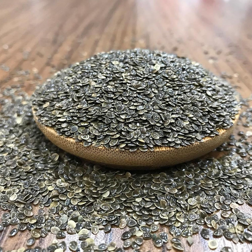Stinging nettle seed powder being mixed into a healthy morning wellness smoothie.