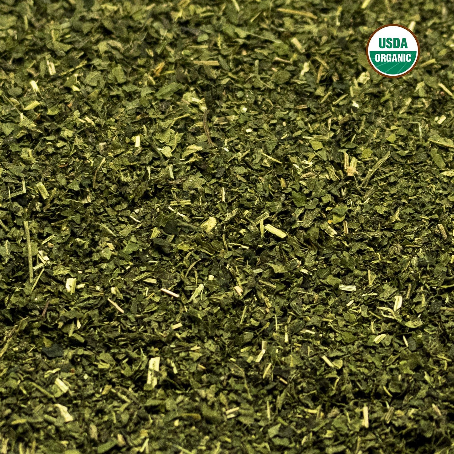 Brewed green herbal stinging nettle tea in a glass cup
