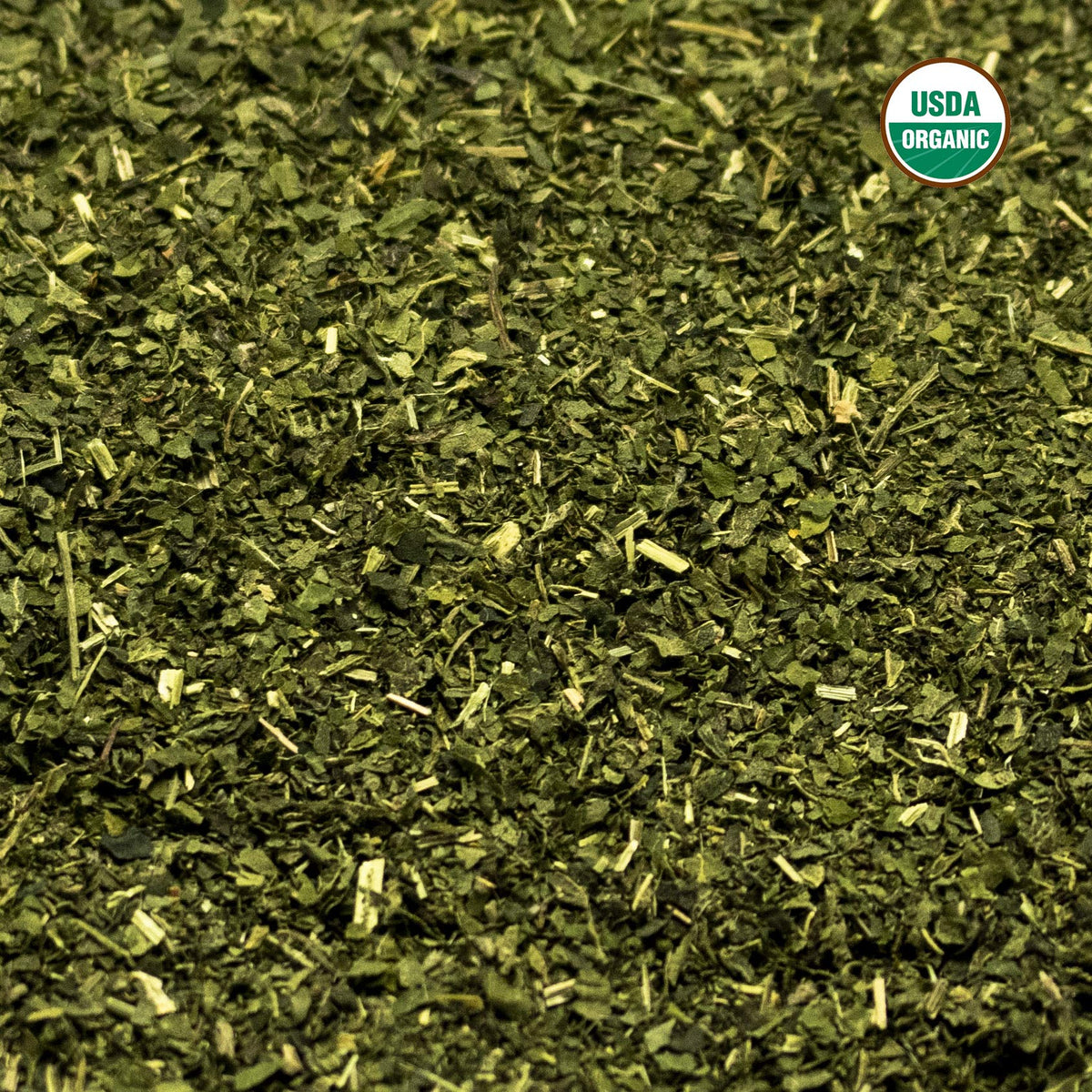 Brewed green herbal stinging nettle tea in a glass cup