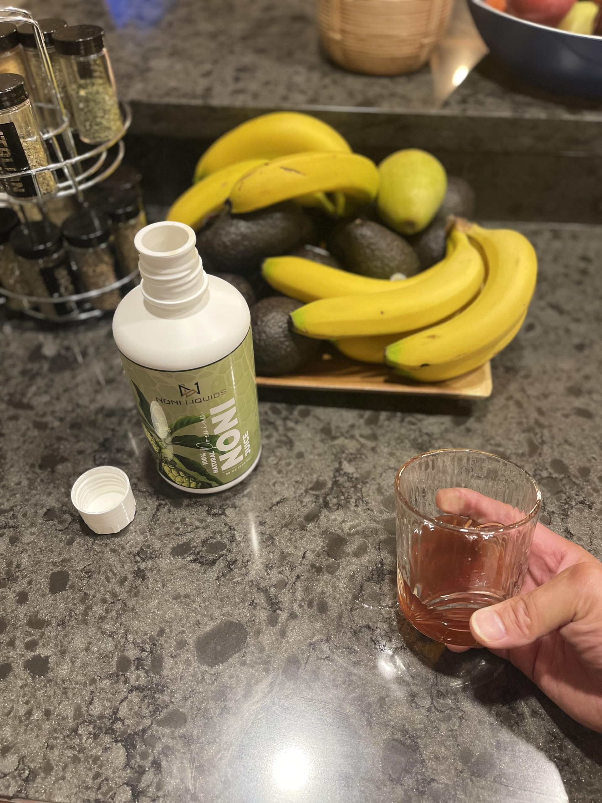 Cold pressed 100 percent pure noni fruit juice bottles highlighting the nutritional facts packaging