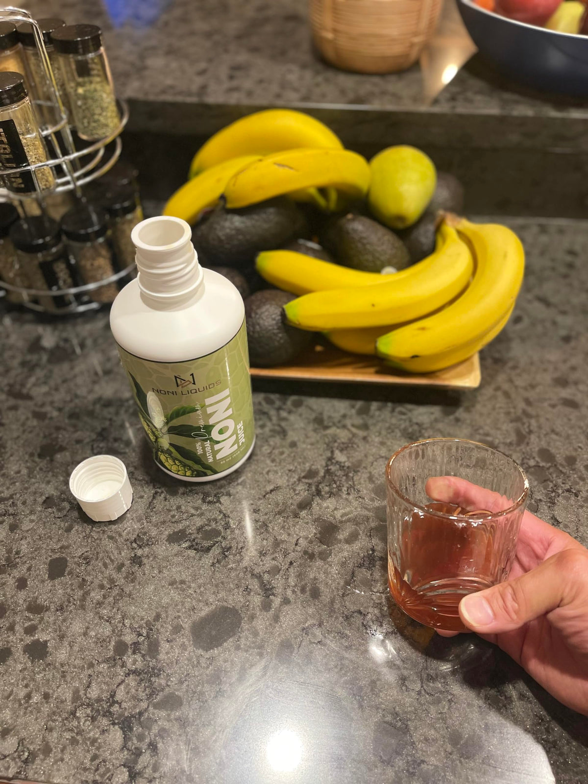 Cold pressed 100 percent pure noni fruit juice bottles highlighting the nutritional facts packaging