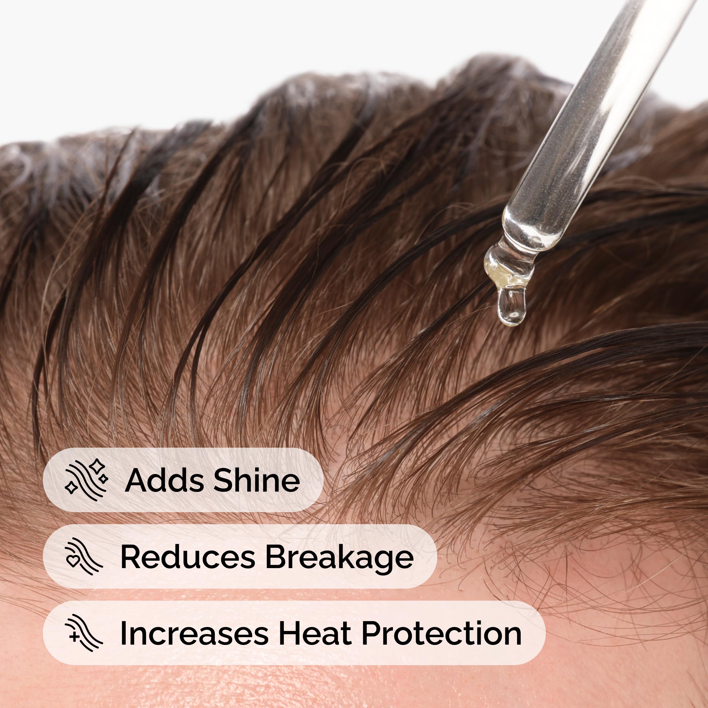 Applying The Ordinary squalane oil to hair for heat protection and shine.