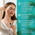 GuruNanda vitamin E oil bottle placed next to natural ingredients