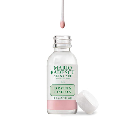 Close up of the Mario Badescu pink sediment bi-phase lotion bottle for targeted overnight acne care.