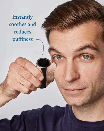 Man applying the Harry's cooling eye stick to the under-eye area for depuffing skincare.